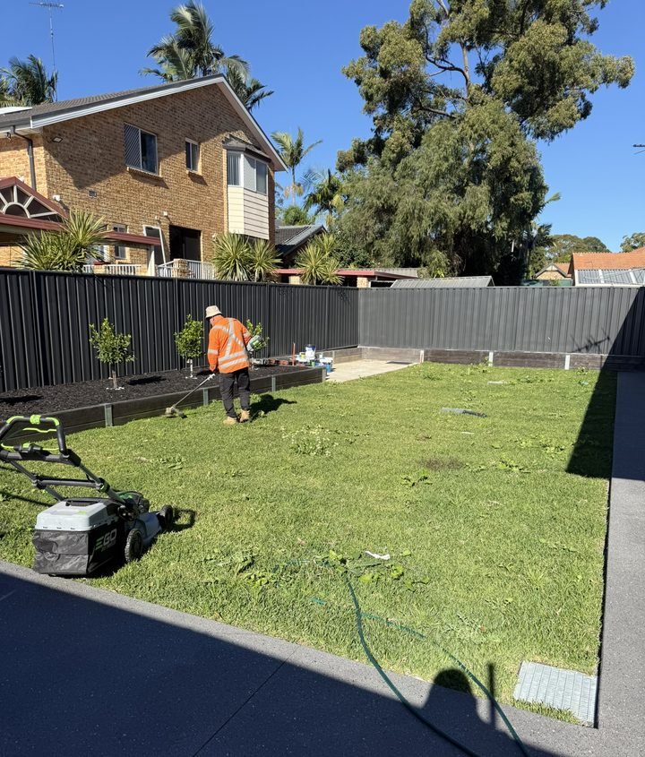 Mowing a newly laid backyard lawn on a PrimeGround job